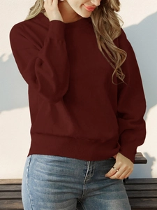 Close-up of deep red long-sleeve knit sweater with rib-knit cuffs and crew neckline