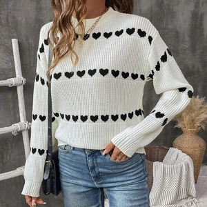 Women white oversized knit sweater with black heart patterns and ribbed crewneck