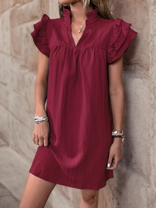 Close-up of wine red summer dress with ruffled v-neckline and layered flutter sleeves
