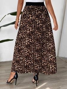 Detail of elegant pleated leopard print skirt featuring a high elastic black waistband