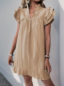 Detailed view of khaki textured pleated fabric with ruffle sleeves and V-neckline