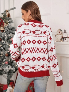 Detail of white Christmas knit sweater with red sheep patterns and ribbed cuffs