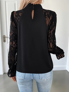 Detail of back neck teardrop cutout and button closure on black lace sleeve top