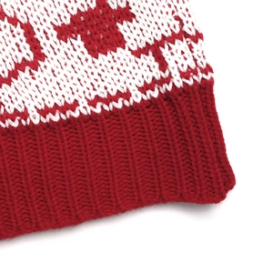 Detail of red and white knitted jacquard pattern with thick ribbed cuffs for Christmas sweater