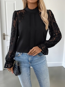 Detail of delicate black lace sleeves and pleated chiffon bodice on a mock neck blouse