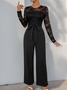 Detail of elegant black lace long sleeves and waist tie on women's chic jumpsuit