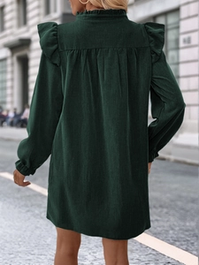 Detailed back view of dark green long sleeve dress featuring ruffle collar and pleated design