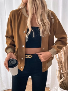 Detail of a brown suede varsity jacket with stand collar and silver metal buttons