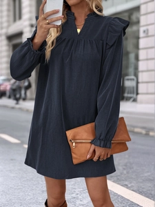 Detailed view of the ruffle stand-up collar and long sleeves on a navy loose dress