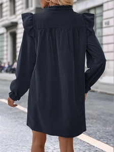 Detail view of ruffle collar and shoulder frills on a navy long sleeve loose dress