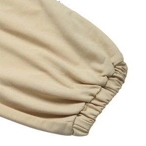 Detailed macro view of beige ribbed knit cuffs with premium stitching on casual pants