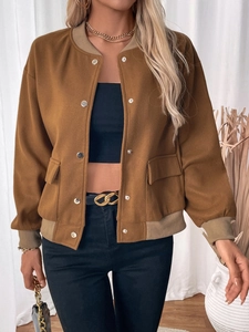 Detail of snap button closure and contrast ribbed collar on tan baseball jacket