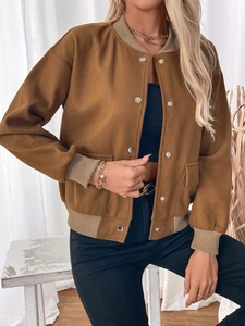 Detail of a brown varsity jacket with ribbed collar, metal snaps, and functional flap pockets