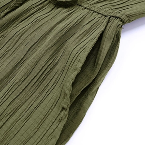 Detailed macro view of military green textured fabric with vertical pleats and side pocket