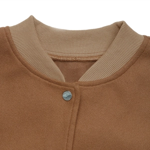 Close-up of brown suede jacket collar with khaki ribbed knit and silver metal button