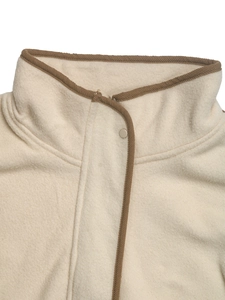 Detail of fleece jacket collar with brown binding and snap button closure