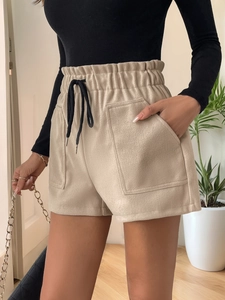 Detail of apricot corduroy high-waisted shorts with elastic waistband and black drawstrings