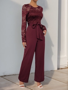 Close-up of wine red lace bodice and high-waist wide-leg jumpsuit with waist tie