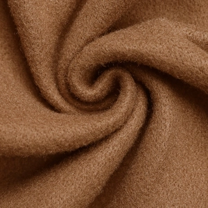 Close-up of thick khaki faux cashmere fabric texture with soft plush finish and drapes