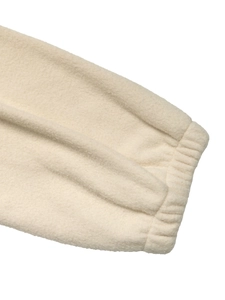 Close-up of elastic ribbed cuffs on a soft off-white fleece jacket for women