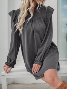 Detailed view of dark grey ruffle dress with V-neckline and elegant long sleeves