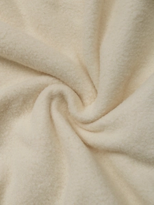 Macro shot of soft cream fleece texture showing the warm and thick plush fabric details