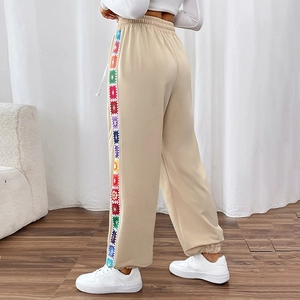 Women's beige jogger with colorful crochet floral stripes and drawstring waist