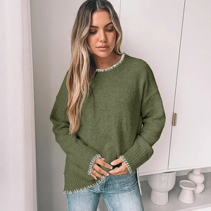 Close-up of olive green knit sweater featuring white contrast stitching on round neckline