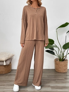 Detail shot of brown ribbed knit texture on long sleeve top and wide leg pants set