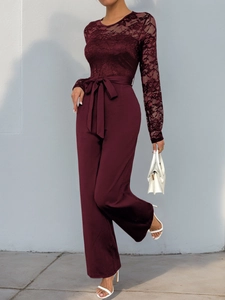 Lace bodice detail of wine red jumpsuit with crochet pattern and waist tie belt