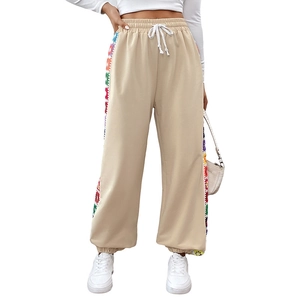 Women's beige loose casual joggers featuring colorful crochet side stripes and drawstring