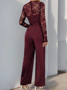 Rear view of a burgundy jumpsuit featuring floral lace sleeves and silky satin wide-leg pants