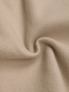 Macro detail of the premium beige wool blend fabric texture on these autumn shorts