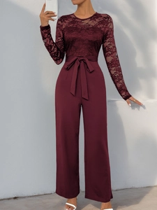 Detail of burgundy jumpsuit with lace crochet sleeves and waist tie belt design