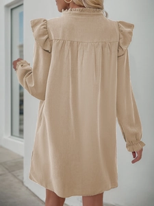Detail of ruffled stand collar and elegant sleeve cuffs on beige long sleeve dress