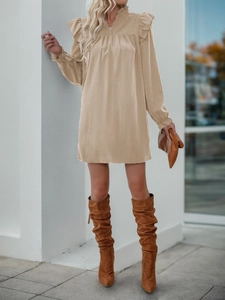 Detailed texture of khaki corduroy mini dress with ruffle shoulders and stand collar