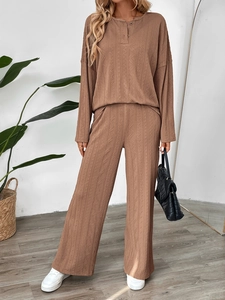 Macro detail of brown knitted texture and button placket on a ribbed two-piece set