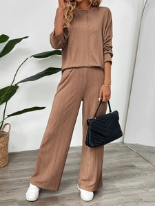Detail of the textured vertical knit and cable stitch pattern on the tan two-piece set
