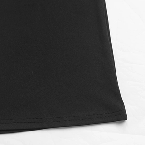 Detail shot of the professional double-needle stitching on black jumpsuit hemline