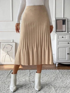 Detailed knit texture of a beige pleated A-line midi skirt for elegant commute