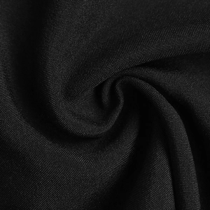 Detailed close-up of premium black fabric texture with soft drape and subtle silk sheen