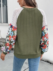 Green knit sweater with floral print puff sleeves and lace paneling shown from the back