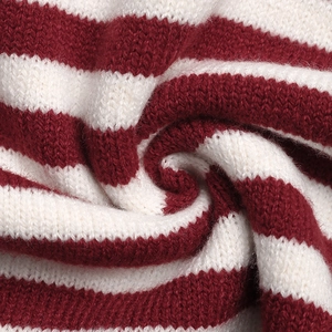Close-up detail of soft red and white striped knit texture on women's hooded sweater