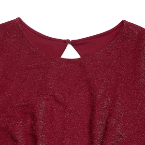 Close-up of burgundy sparkly knit fabric neck with teardrop cutout and button detail