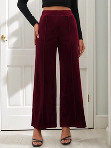 Close-up of high-waist velvet wide-leg pants in burgundy with vertical seam details