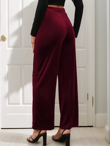 Back view of elegant burgundy velvet wide-leg trousers with high waist design