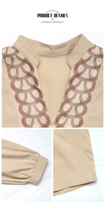 Detail of V-neck collar with circular pattern and cuffed sleeves on beige blouse