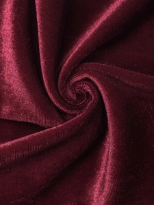 Macro detail of wine red velvet fabric with soft silk sheen and luxurious texture