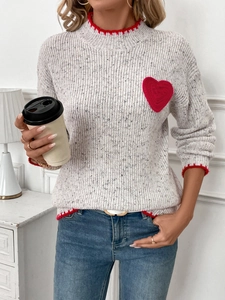 Women's heart knit sweater with red scalloped edges and colorful flecks in cream