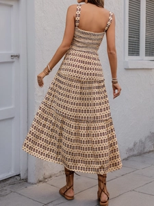 Detail of bohemian tiered maxi dress featuring shirred elastic back and geometric pattern